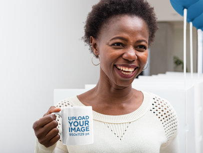 Mockup of a Woman Holding an 11 oz Coffee Mug at an Office 