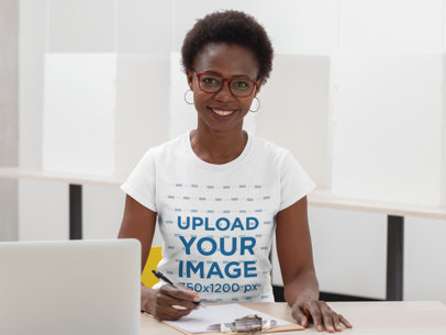 T-Shirt Mockup Featuring a Smiling Woman Taking Notes