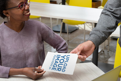 Mockup of a Woman Handing Out a Flyer to a Man 