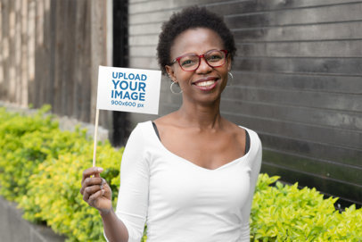 Mockup of a Woman Happily Holding a Flag 