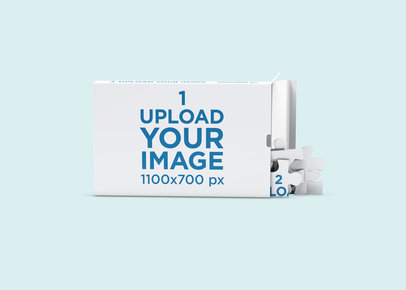 Puzzle Mockup Featuring a Box and Some Pieces Against a Solid Color Backdrop