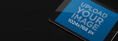 Black iPad Mini Mockup Featuring a Dark Background 