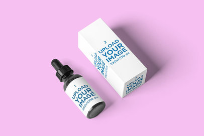 Mockup of a Dropper Laid on a Customizable Surface Next to Its Box 2733-el1