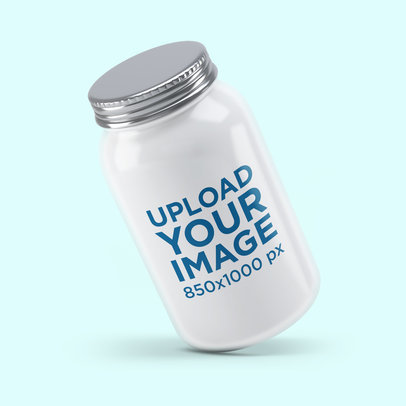 Mockup of a Tilted Mason Jar Against a Plain Backdrop