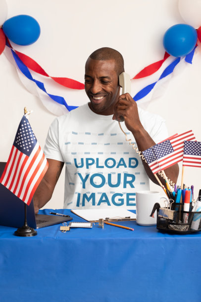 Tee Mockup with a Man Holding a Telephone at a Political Campaign Headquarters