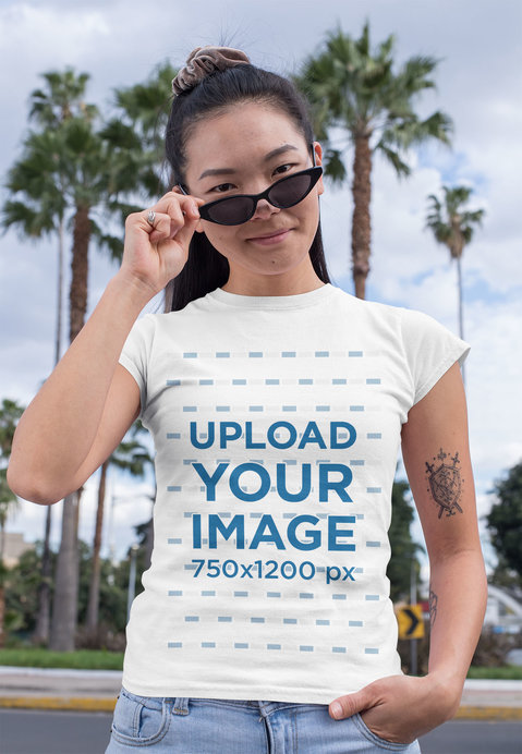 Crewneck T-Shirt Mockup Featuring a Woman with Sunglasses at an Urban Environment 