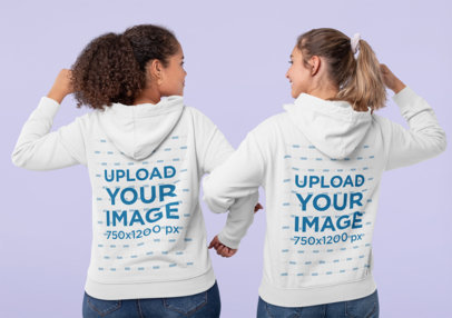 Hoodie Mockup of Two Women Making a Strong Pose Together