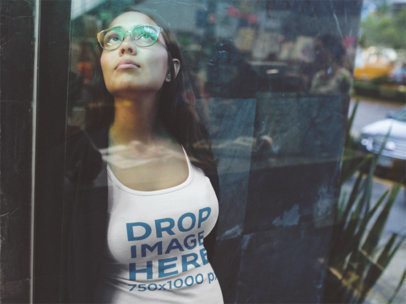 Urban-Style Mockup of a Woman in the City Wearing a Tank Top