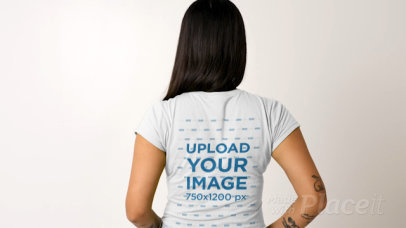 Back View T-Shirt Video Featuring a Long-Haired Woman Posing against a Plain Background 