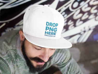 Young Man Sitting With a Snapback Hat Mockup