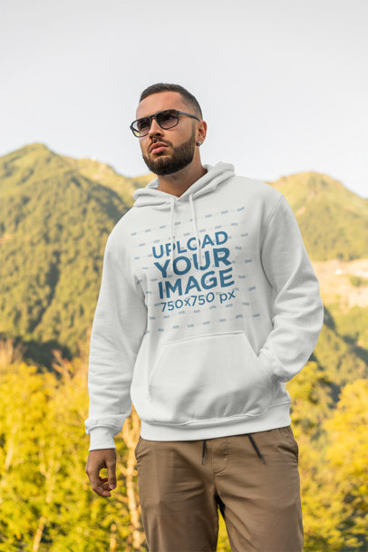 Hoodie Mockup of a Bearded Man Standing Over a Hill