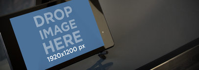 Mockup of a Nexus 7 Placed on a Dark Table 
