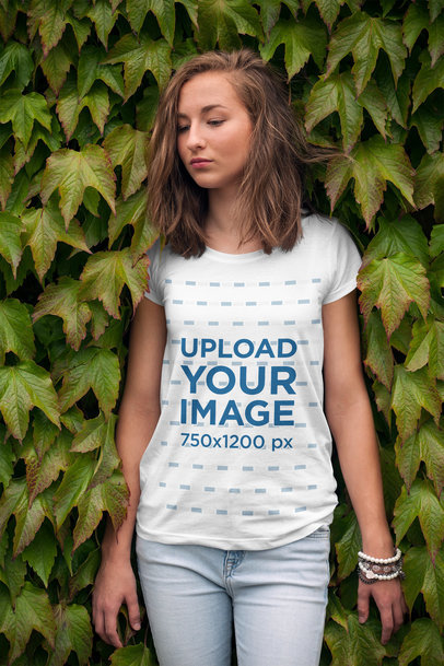T-Shirt Mockup of a Young Woman Leaning on a Wall of Ivy