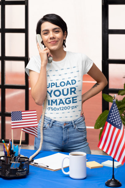 T-Shirt Mockup Featuring a Woman on the Phone in a Political Polling Station 