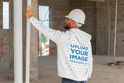 Mockup of a Man Wearing a Hoodie and Working on a Construction 