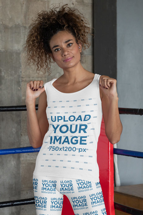 Mockup of a Woman Showing Off Her Tank Top and Leggings at a Boxing Gym 