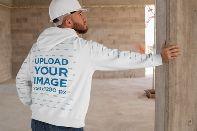Hoodie Mockup with Printed Sleeves Featuring a Man at a Construction Site