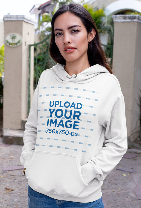 Mockup of a Brunette Woman Wearing a Pullover Hoodie on the Street