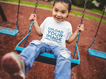 T-Shirt Mockup of a Little Girl Playing on a Swing