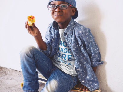 Kid's T-Shirt Mockup of a Young Boy Eating an Apple