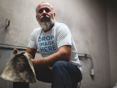 T-Shirt Mockup of a Senior Man Crouching in a Garage a12061