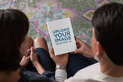 Mockup of a Woman and a Man Holding a Paperback Book