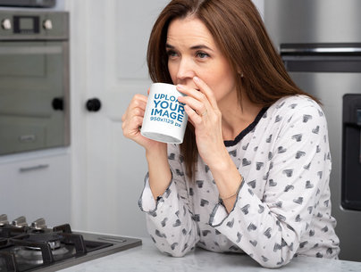 11 oz Mug Mockup of a Woman Drinking Coffee in the Kitchen 