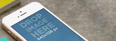 Mockup of an iPhone 5 on a Concrete Table