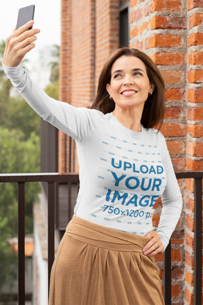Long Sleeve Tee Mockup of a Middle-Aged Woman Taking a Selfie in the Balcony 