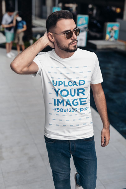 T-Shirt Mockup of a Bearded Man Casually Walking Down the Street 