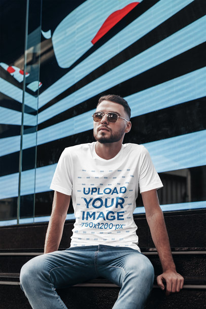 T-Shirt Mockup Featuring a Man with Sunglasses in an Urban Setting