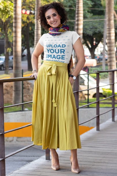 T-Shirt Mockup of a Stylish Middle-Aged Woman Posing by a Handrail 