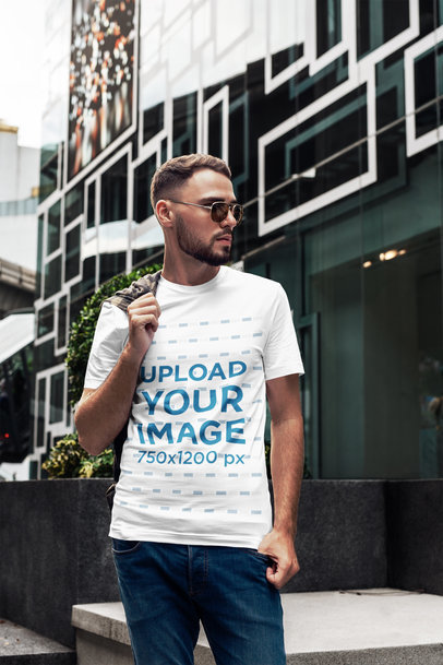 T-Shirt Mockup of a Bearded Man Posing Next to a Cool Building 2816-el1