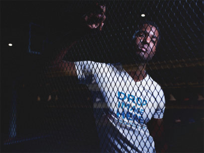 V-Neck Tee Mockup of a Handsome Black Man Behind a Fence a12155