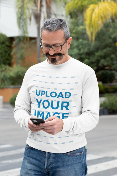 Long Sleeve Tee Mockup of a Man Texting with a Smile on His Face