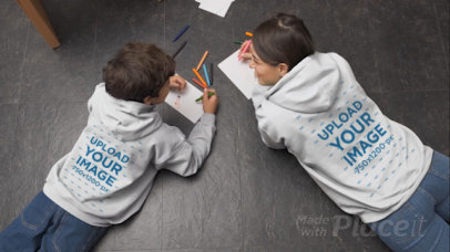 Hoodie Video Featuring a Woman and Her Son Drawing on the Floor
