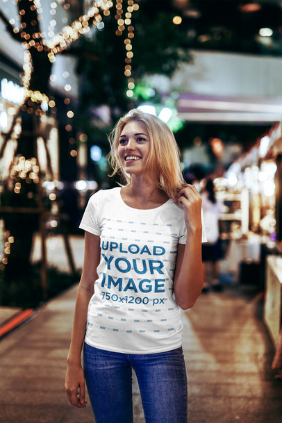 T-Shirt Mockup of a Woman Holding Her Hair on the Street at Night