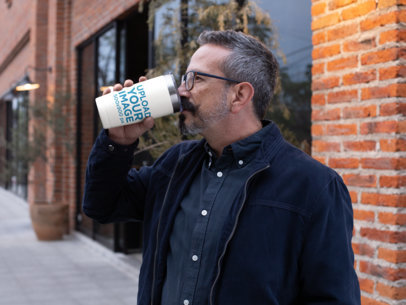 Mockup of a Bearded Man Drinking From a Travel Mug