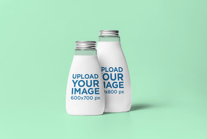 Mockup of Two Glass Bottles Against a Customizable Background 