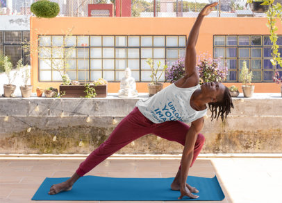 Mockup of a Man Wearing a Tank Top and Doing Yoga at a Balcony