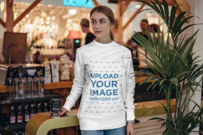 Sweatshirt Mockup of a Young Woman at a Marketplace 