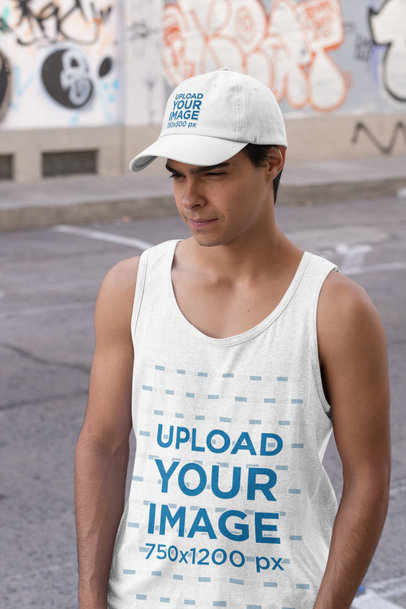 Tank Top Mockup of a Man Wearing a Dad Hat in an Urban Scenario 