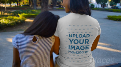 T-Shirt Video of a Girl and Her Mother Sitting at a Park 