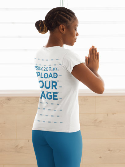 Back View T-Shirt Mockup Featuring a Woman Practicing Yoga