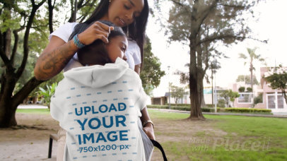 Hoodie Video of a Girl Hugging Her Mom at a Park 