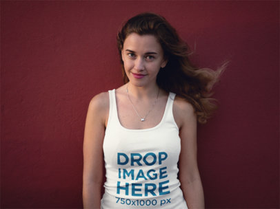 Young Woman Wearing a Tank Top Against a Wall Mockup
