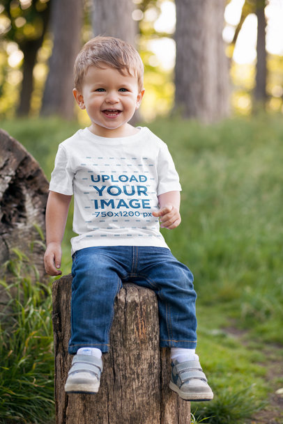 T-Shirt Mockup of a Toddler Sitting on a Log