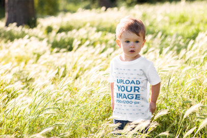 T-Shirt Mockup of a Little Boy Surrounded by Tall Grass