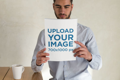 Mockup Featuring a Young Man Holding a Magazine 