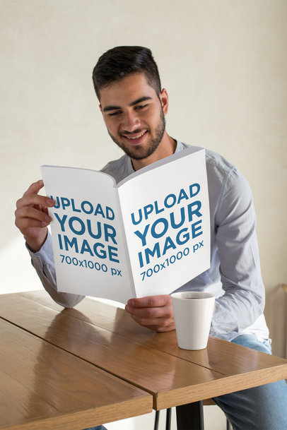 Mockup Featuring a Man Smiling While Reading a Magazine 